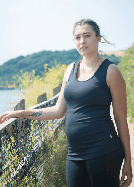 FittaMamma pregnancy activewear top worn outdoors, offering comfort and support for active moms-to-be on walks or hikes.